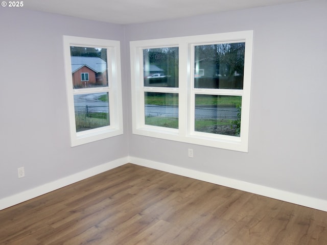 empty room with hardwood / wood-style floors