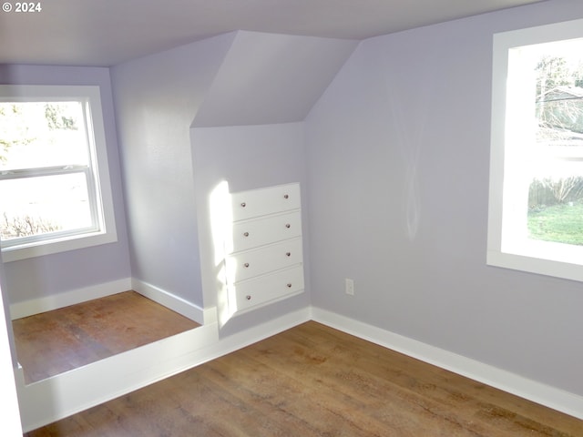 bonus room featuring dark hardwood / wood-style flooring and lofted ceiling