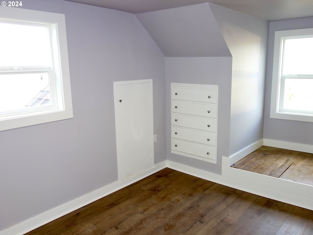 bonus room featuring vaulted ceiling and dark hardwood / wood-style flooring