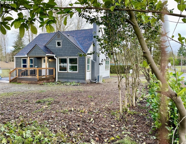 view of front of house featuring cooling unit and a deck