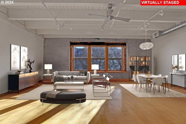 living room featuring a high ceiling, ceiling fan, and light hardwood / wood-style flooring