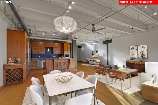 dining area with rail lighting, ceiling fan, wood-type flooring, and sink