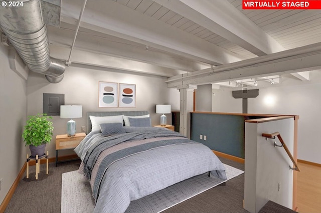 bedroom featuring beam ceiling and dark colored carpet