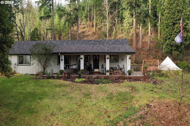 ranch-style home with covered porch and a front yard