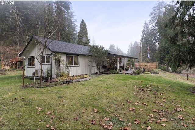 view of front of property featuring central AC and a front lawn