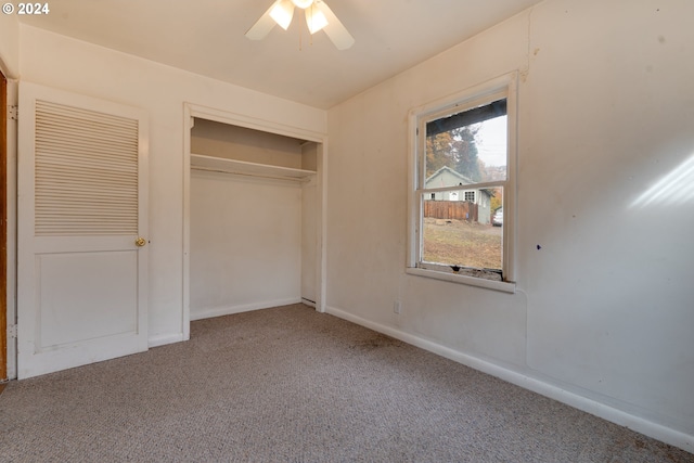 unfurnished bedroom featuring carpet flooring, ceiling fan, and a closet