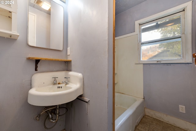 121 Garrett Ave, Klickitat, WA 98628 - full bathroom featuring a tub to relax in, a sink, tile patterned floors, and baseboards