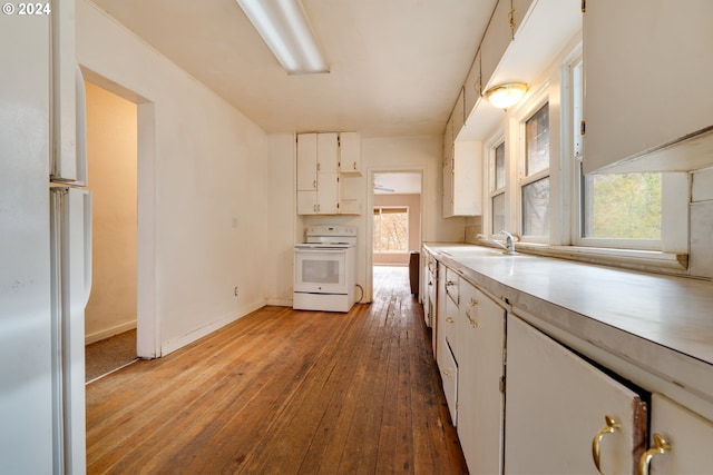 kitchen featuring light wood-type flooring, white range, white cabinetry, and sink