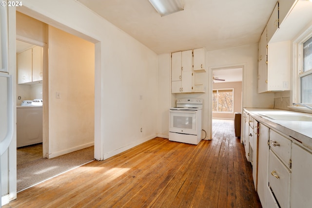 121 Garrett Ave, Klickitat, WA 98628 - kitchen with electric stove, washer / dryer, a sink, and white cabinets