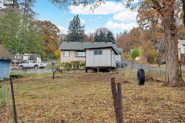 back of property featuring a lawn