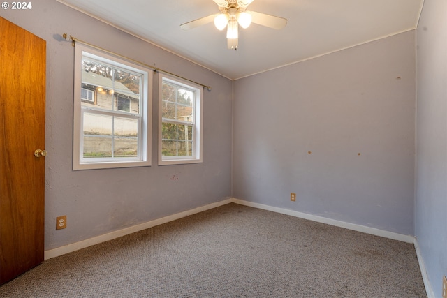 carpeted spare room featuring ceiling fan