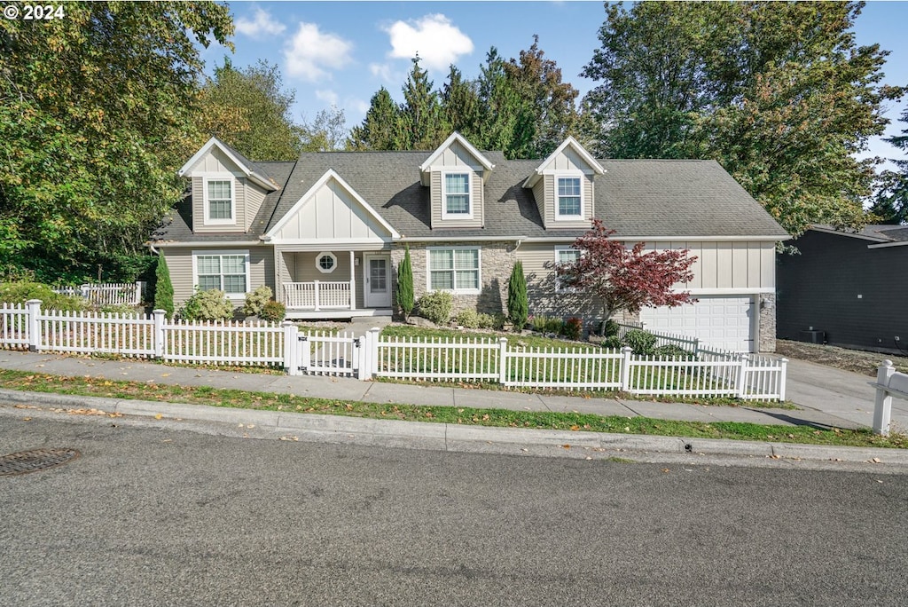 new england style home with a porch and a garage