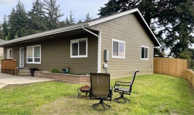 back of property featuring a yard, fence, and a patio