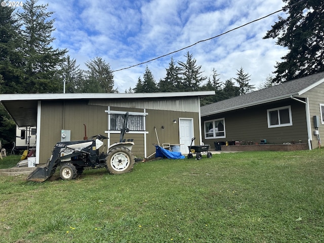 exterior space with an outbuilding and a lawn