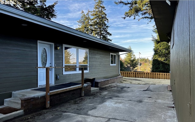 view of side of home featuring a patio area and fence