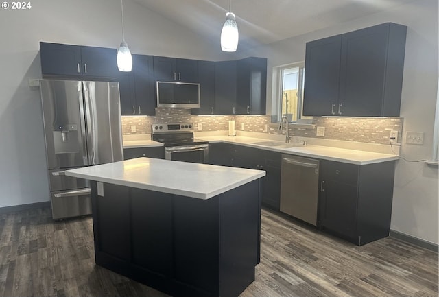 kitchen featuring dark wood-style flooring, stainless steel appliances, a sink, and light countertops