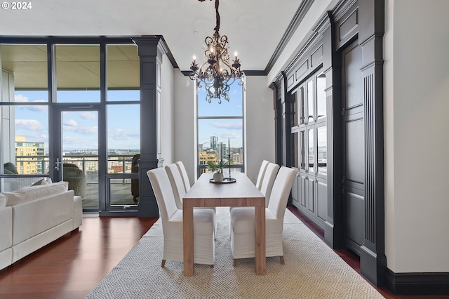 dining space featuring floor to ceiling windows, dark hardwood / wood-style floors, crown molding, and an inviting chandelier