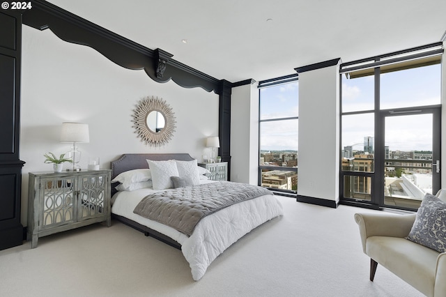 bedroom featuring light colored carpet, expansive windows, and ornamental molding