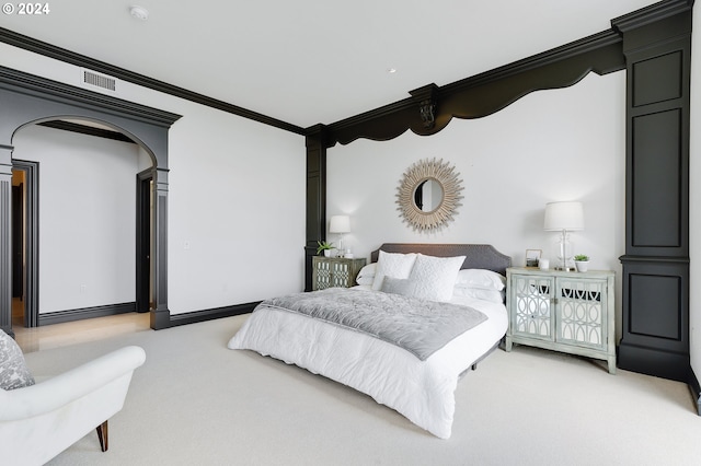 bedroom with light colored carpet and ornamental molding