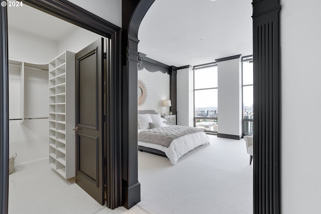 carpeted bedroom featuring expansive windows