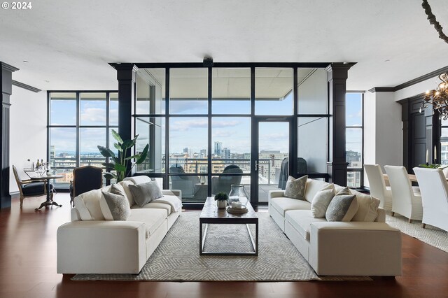 living room with floor to ceiling windows, dark hardwood / wood-style floors, and ornamental molding