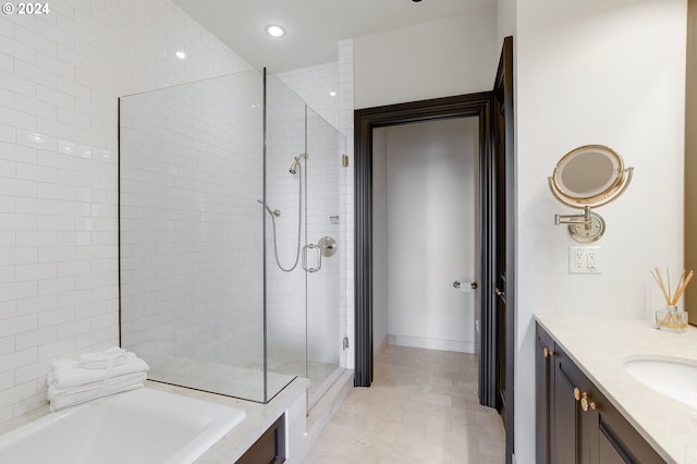 bathroom with shower with separate bathtub, tile patterned floors, and vanity