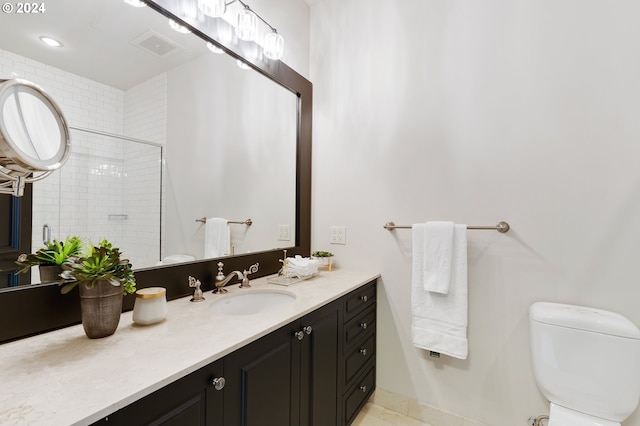 bathroom with vanity, toilet, and walk in shower