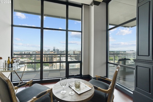 dining room featuring a healthy amount of sunlight, dark wood-type flooring, and expansive windows