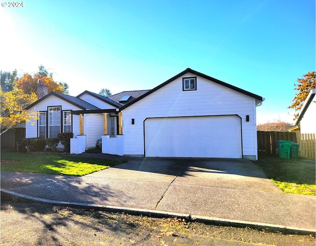 ranch-style home with a garage and a front lawn