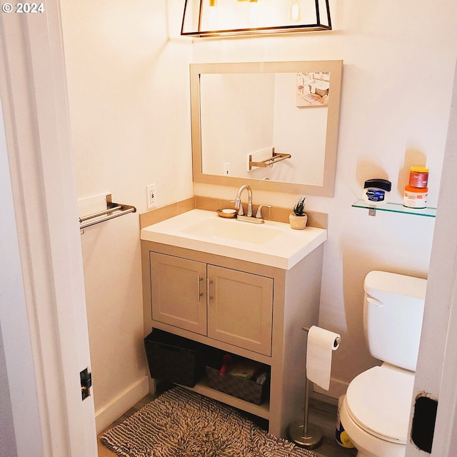 bathroom featuring vanity and toilet