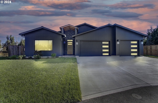 contemporary home featuring a lawn and a garage