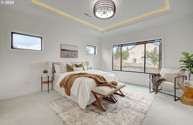 bedroom featuring baseboards, visible vents, and a raised ceiling