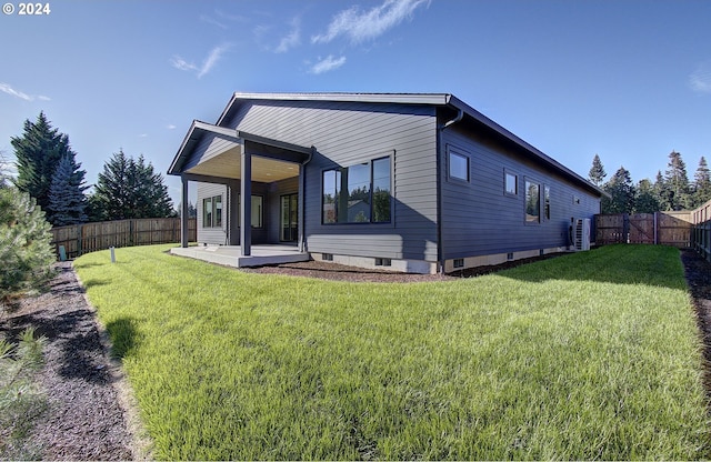 back of property featuring a fenced backyard and a yard