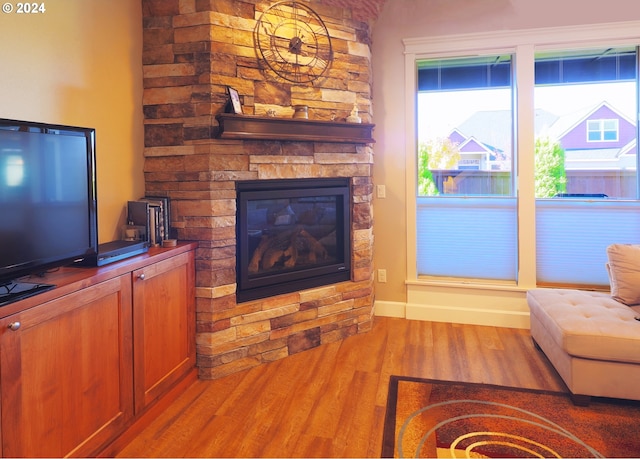 living room with a fireplace and light hardwood / wood-style flooring