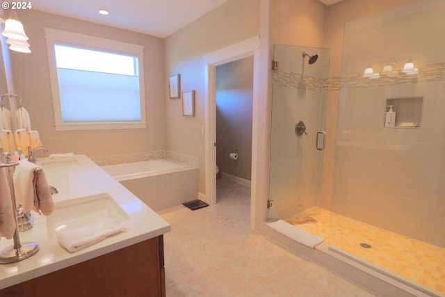 full bathroom featuring toilet, vanity, and separate shower and tub