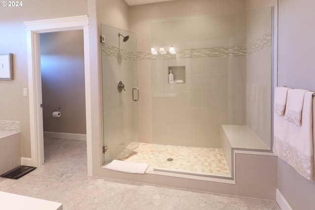 bathroom with tile patterned flooring and a shower with door