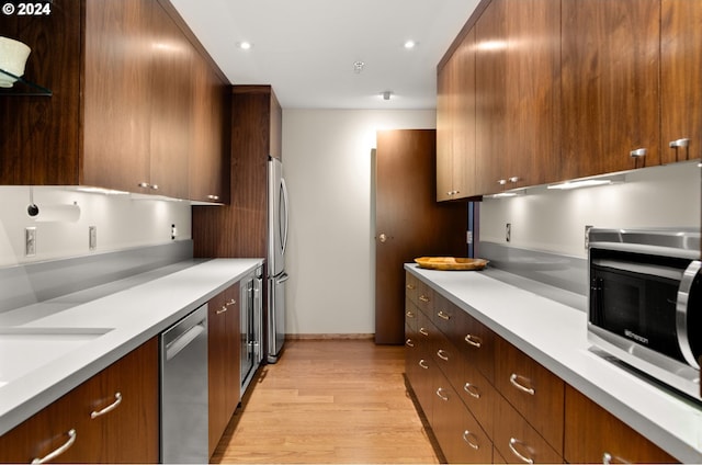 kitchen featuring stainless steel appliances and light wood-type flooring