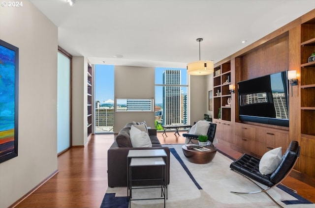 living room with dark wood-type flooring, built in features, and expansive windows