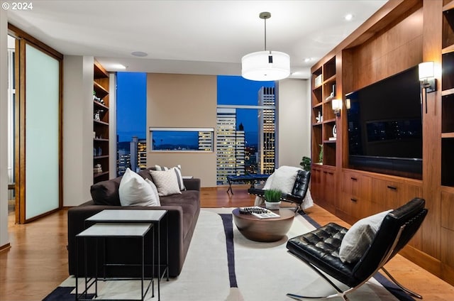 living room with light hardwood / wood-style floors and built in features