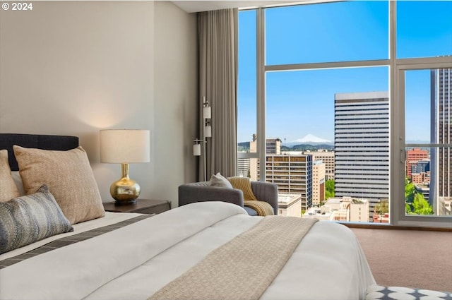 carpeted bedroom with a wall of windows