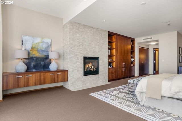 carpeted bedroom with a fireplace