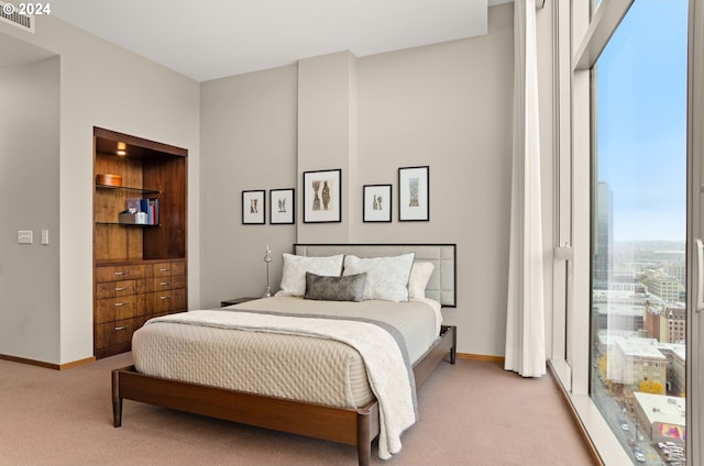 bedroom featuring light carpet