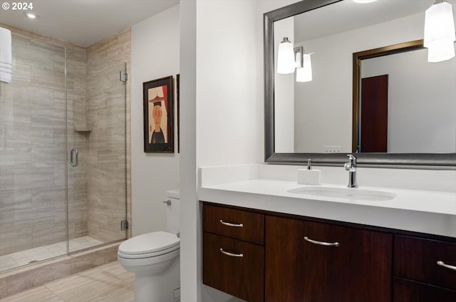 bathroom featuring toilet, tile patterned floors, walk in shower, and vanity