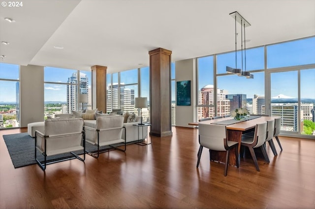 dining area with floor to ceiling windows, plenty of natural light, and dark wood-type flooring