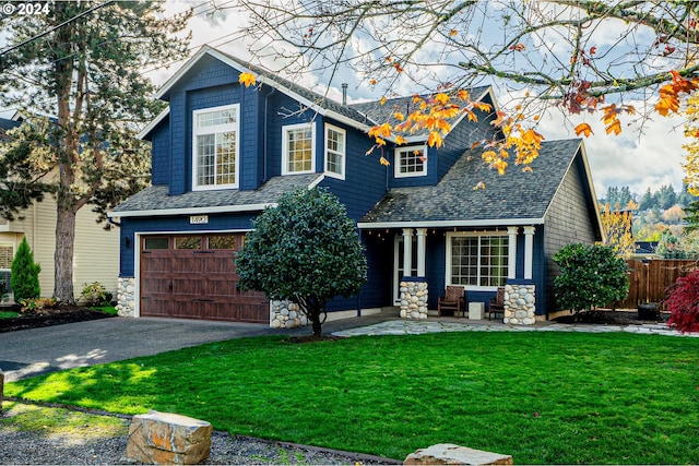 view of front facade featuring a front yard and a garage