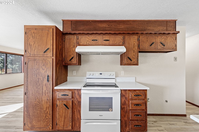 kitchen with light hardwood / wood-style flooring, white range with electric cooktop, and a textured ceiling