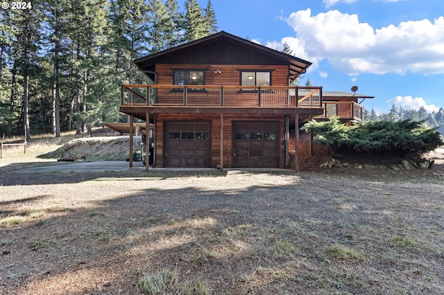 exterior space featuring a garage and a wooden deck