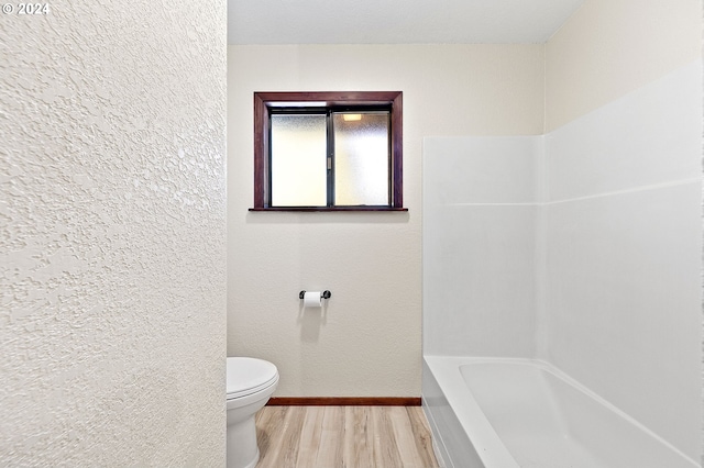 bathroom featuring hardwood / wood-style flooring and toilet