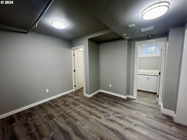 basement with hardwood / wood-style flooring