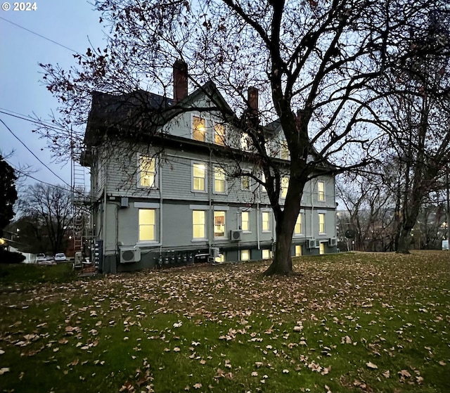 back of house with a lawn